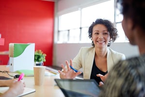 Unposed group of creative business people in an open concept office brainstorming their next project.-1