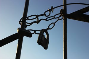 A chain link fence with a sky background