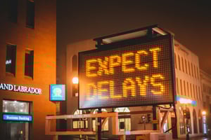 city street with construction sign at night